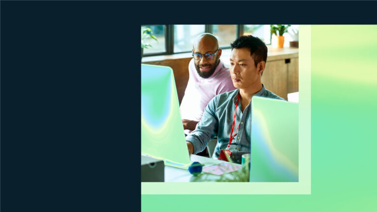 Two security practitioners look at a computer screen together