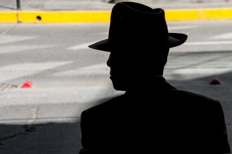 silhouette of a man in black hat
